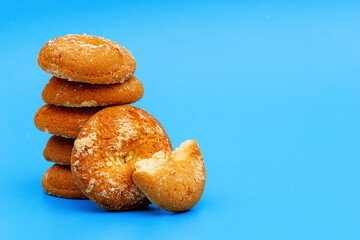 heap of cookies on blue background with copy space