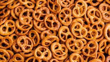 food background: lots of crispy pretzels with salt