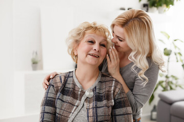 happy senior mother and adult daughter closeup portrait at home