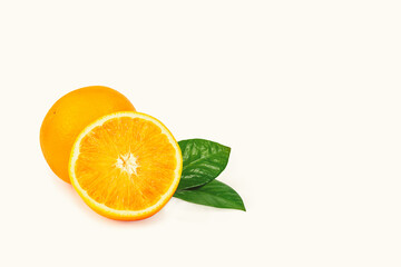 The orange is isolated. Whole fruit and half with leaves on a white background.