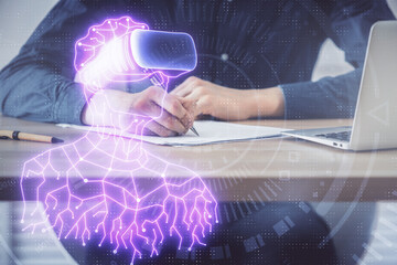Abstract man wearing augmented reality headsets computer work with writing human background. AR concept. Double exposure.