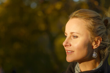Beautiful woman posing in a autumn park