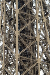 Close-up of a leg with an elevator of the famous iron landmark - the Eiffel Tower in Paris, France, Europe
