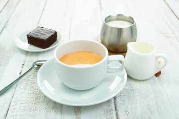 Tea and fresh milk in a beverage glass on the table