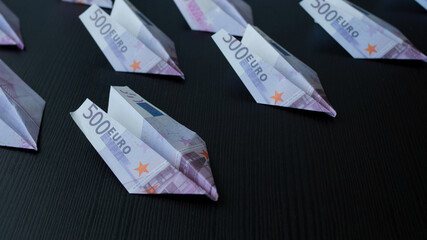 Paper airplanes made of Euro banknotes, the concept of cash flow.