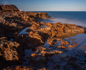 sea water hitting the shore stones with silk effect