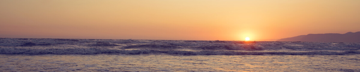 panoramic view of seascape with yellow sun ball on sea coast