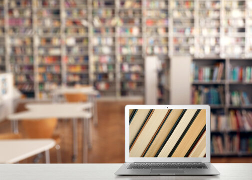 Digital library concept. Modern laptop on table indoors, space for text