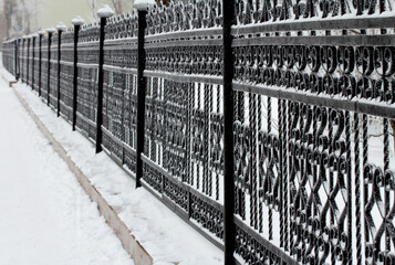 metal decorative fence in the snow