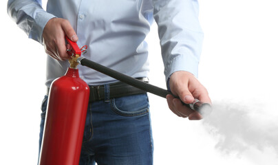 Man using fire extinguisher on white background, closeup - obrazy, fototapety, plakaty