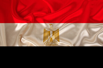 photo of the national flag of the state of Egypt on a luxury texture of satin, silk with waves,...