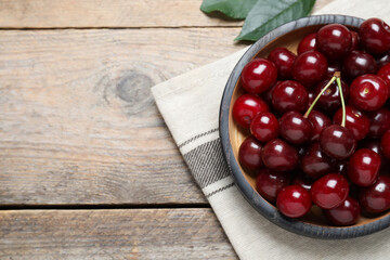 Sweet juicy cherries on wooden table, flat lay. Space for text