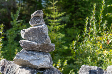Stone stack in green wood