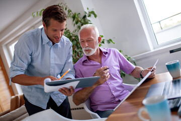 Two businessmen working on laptop.