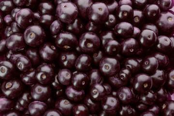 Fresh ripe acai berries as background, closeup