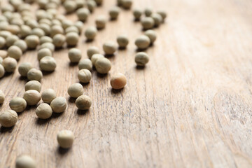 Fototapeta na wymiar Raw dry peas on wooden background, closeup with space for text. Vegetable seeds