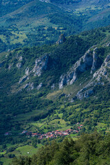 Fototapeta premium Small town seen from the Chapel of Santa María in Bermiego in the Quirós council, in the Las Ubiñas-La Mesa Natural Park. Asturias. Spain.Europe