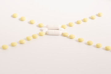 line from multi-colored pills on a white background.