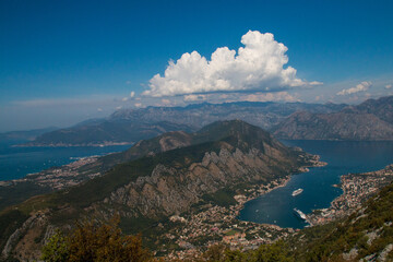 Fototapeta premium Bay of Kotor from the heights. View from Mount Lovcen to the bay. View down from the observation platform on the mountain Lovcen. Mountains and bay in Montenegro. The liner near the old town of Kotor.