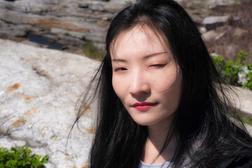 A chinese woman winking at the camera