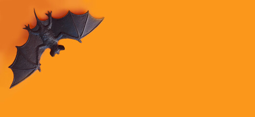 halloween banner. figurine of a bat on an orange background, copy space, place for text. animal, flyer, invitation
