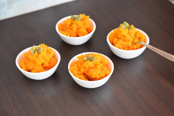 delicious and fresh tasty carrot halwa with ghee and pumpkin seed on topping