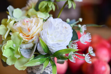Bright assorted-colored artificial flowers in a vase