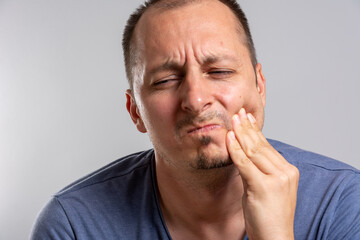 Fototapeta premium Toothache, medicine, health care concept, Teeth Problem, young man suffering from tooth pain, caries