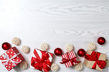 Christmas gift box, Christmas ball Ornaments on white wood top flat layout blank copy space for text.