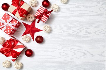 Christmas gift box, Christmas ball Ornaments on white wood top flat layout blank copy space for text.