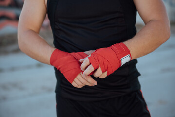 Closeup male hand of boxer with red boxing bandages.