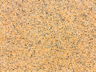 Stone background of mottled granite igneous rock used in construction, as a finishing material for kitchen countertops, etc.