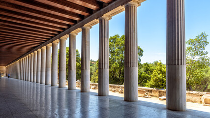 Perspective of classical building columns in ancient Agora, Athens, Greece. Panoramic view inside the Stoa of Attalos - obrazy, fototapety, plakaty