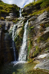 Obraz premium La cascata del Falco sul monte Cervino fa scorrere giù a valle la sua acqua fresca proveniente dal ghiacciaio sovrastante