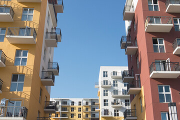 Colorful residential buildings with a blue sky background. Vivid colorful blocks of flats.