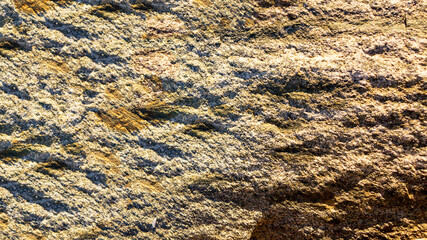 Stone background of mottled granite igneous rock used in construction, as a finishing material for kitchen countertops, etc.