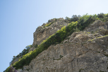 Mountain peaks against cloudy sky. Peaks of magnificent rocks located against bright cloudy sky on sunny day in nature