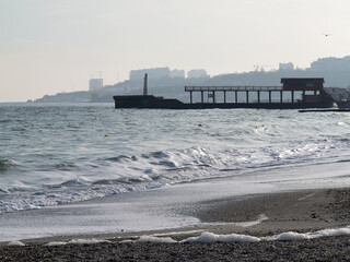 Huge stormy waves crashing near city embankment, dramatic sky on background/Big sea wave splash/ Giant waves on stormy.