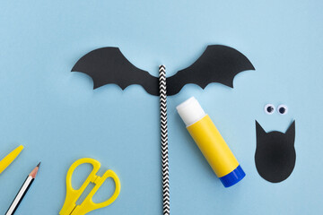 Halloween crafts. How to make funny paper bat. Glue wings, step 3. Top view, flat lay
