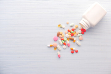 Fototapeta na wymiar top view of colorful pills and capsule spilling 