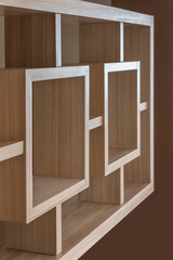 Fototapeta premium light brown wooden furniture, geometric lines and minimalist style with squares and brown wall background