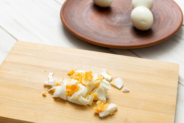 chopped chicken eggs on a cutting board. Ingredient for cooking