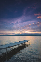 Fototapeta premium Bright color of the morning fill the sky over a dock on Lake Bernard in Ontario, Canada.