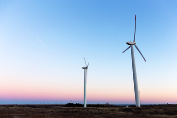 Wind Turbines at Dusk. Landscape sunset with windmills. Renewal source of electricity. Wind...