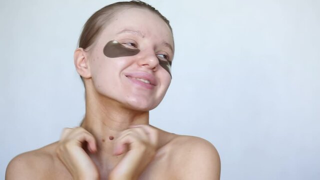 Beautiful caucasian woman with hydrogel eye patches on her face. Care for the skin. Healthy skin. Cosmetology procedure