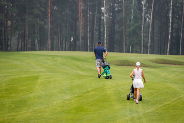 The Golfers walk across the field during the tournament.