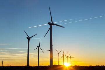 Wind Turbines at Dusk. Landscape sunset with windmills. Renewal source of electricity. Wind turbines field new technology for clean energy on mountain, sunset view with colorful twilight on sky