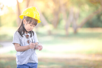 A close-up view of a cute Asian girl. Who are simulating learning outside of the classroom, event planning, designing on the mechanic
