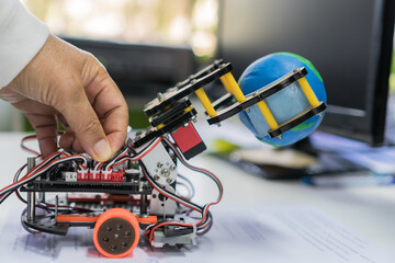 robotics stem coding programming AI smartphone control and learning STEM Education for Learn coding programming using Control robot to pick up model globe by robotics electronics