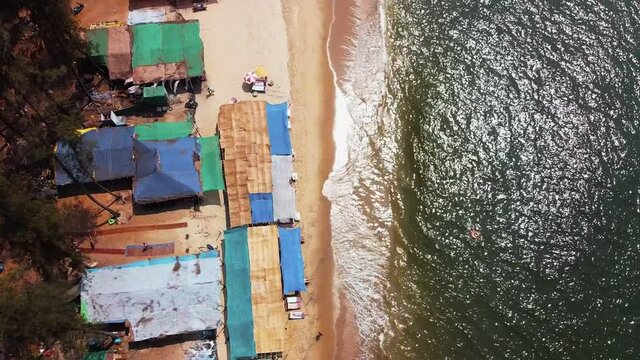 Drone footage Fly over the beautiful deserted Kerim Beach with a beach shack in Goa India at sunny day